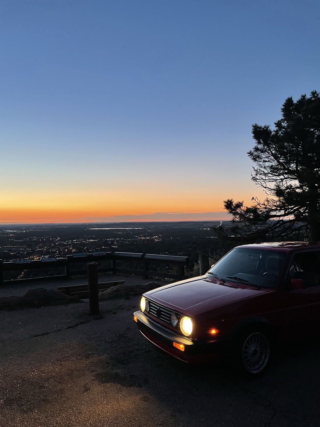 The GTI at the overlook, headlights on at sunset